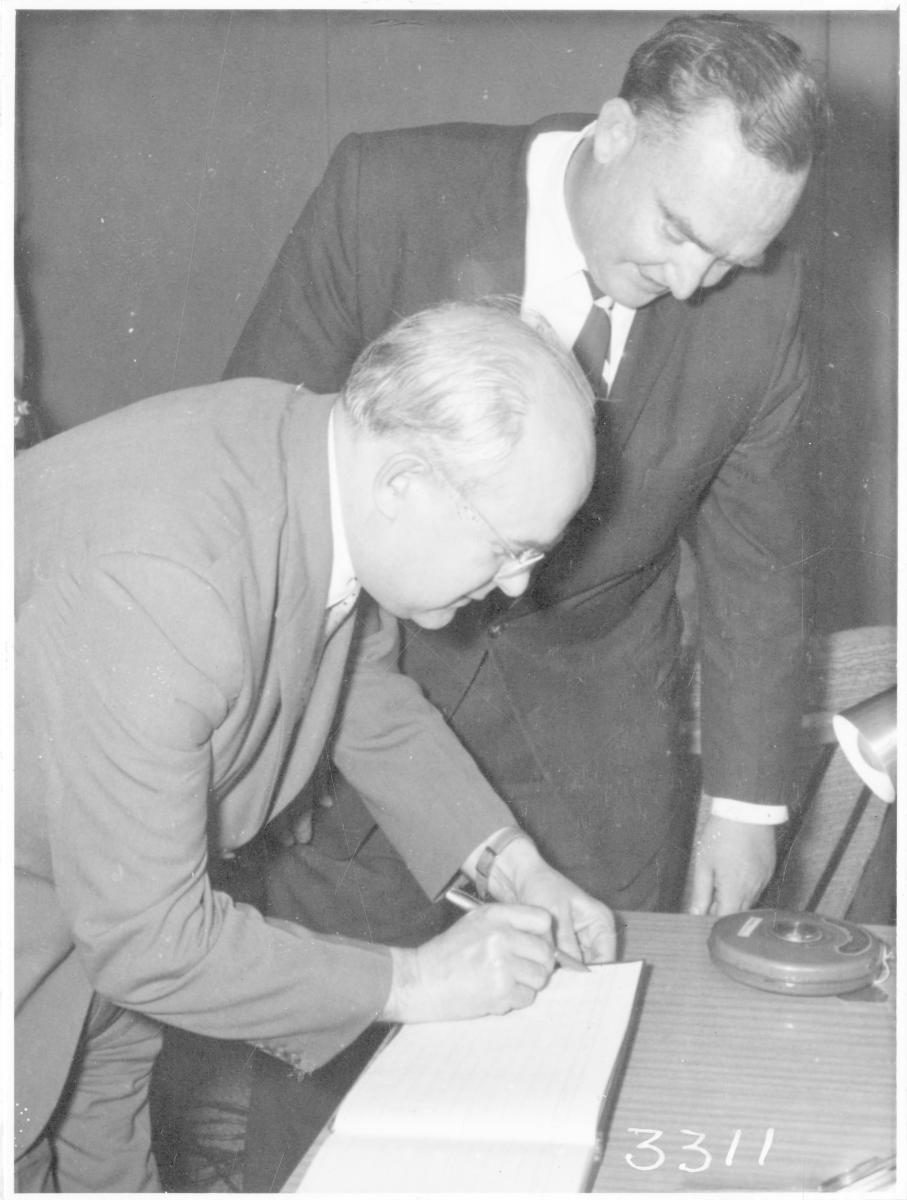 Mr Ivan Kurdiukov, Soviet Ambassador, signing the visitors book at the airport, Brisbane, 14 November 1960