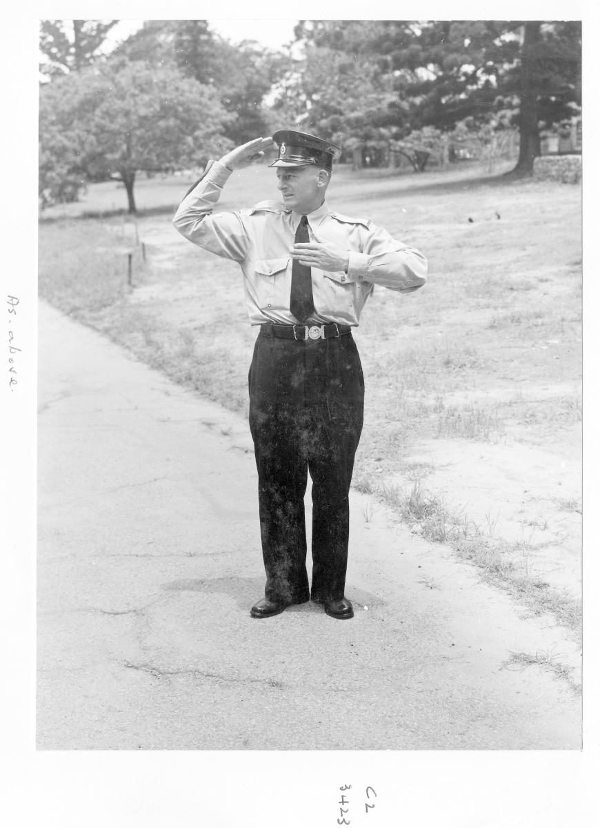 Demonstrating traffic hand signals - Brisbane, December 1959