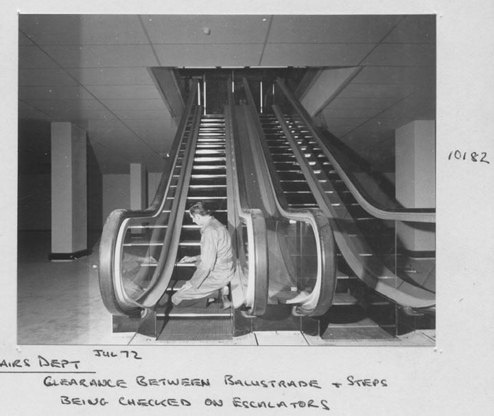 State General Insurance Office (SGIO) building - Clearance between balaustrade and steps being checked on escalators - Brisbane, July 1972