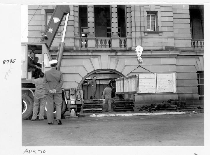 Camera rear section being unloaded and directed through window opening, William Street, Brisbane, April 1970