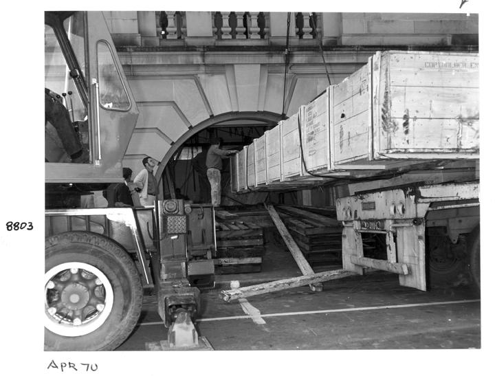 Camera main beam being unloaded and directed through the window opening, William Street, Brisbane, April 1970