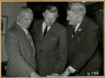 Queensland Premier Nicklin, Chairman of the Anzac Day Commemoration Committee handing over a cheque of £7000 to the Lord Mayor of Brisbane, Ald Clem Jones as a contribution to the Anzac section of Mt Gravatt Cemetery, 21 September 1961