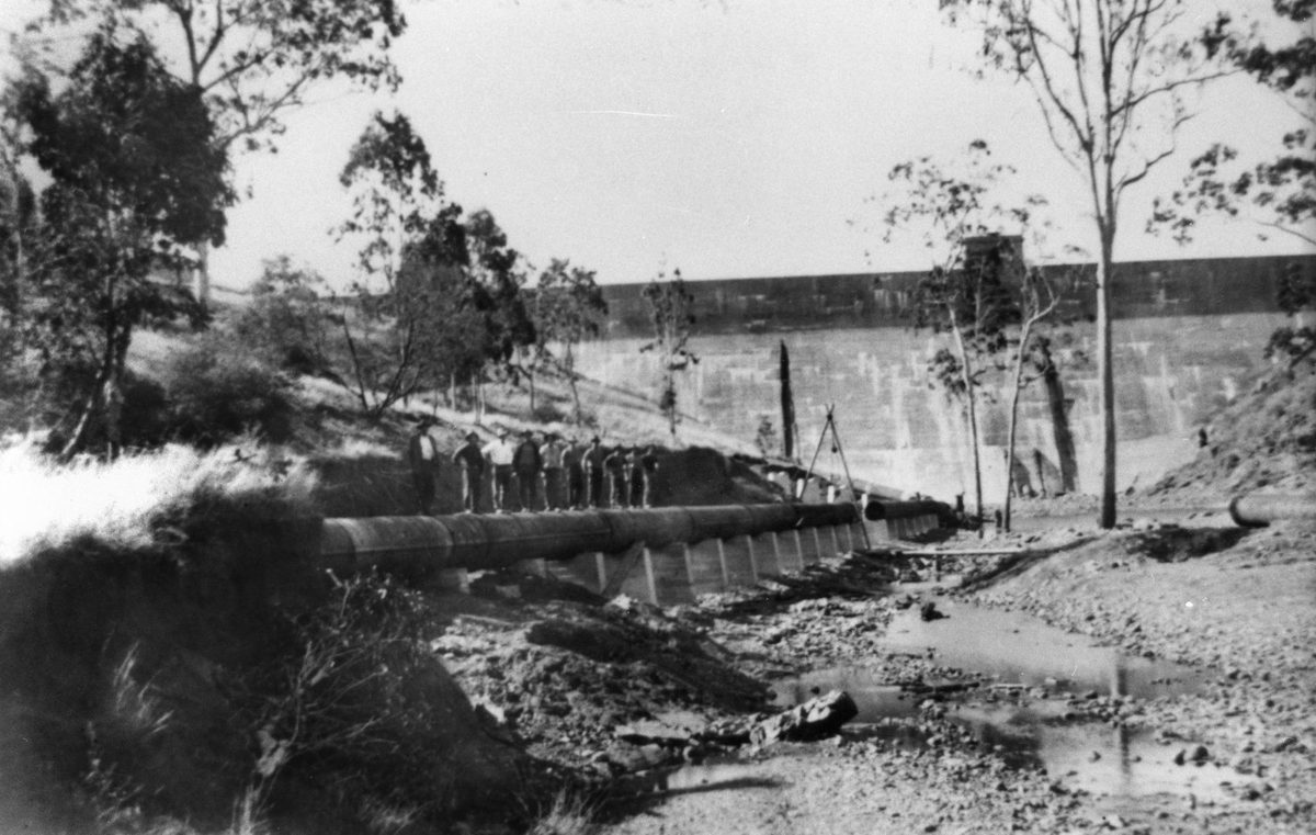 Workmen on the pipework beside Lake Manchester Dam wall, 1931