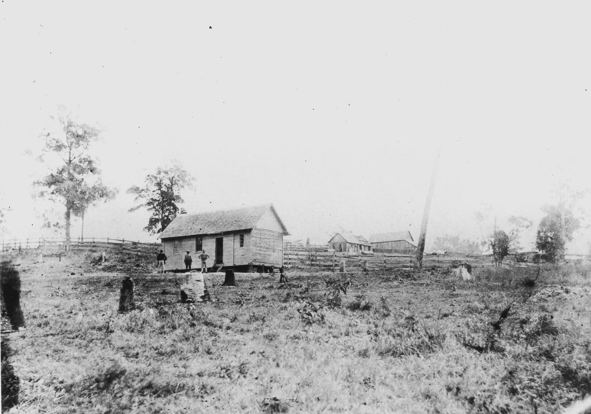 Workers outside their hut at Enoggera, possibly at the reservoir site, 1869