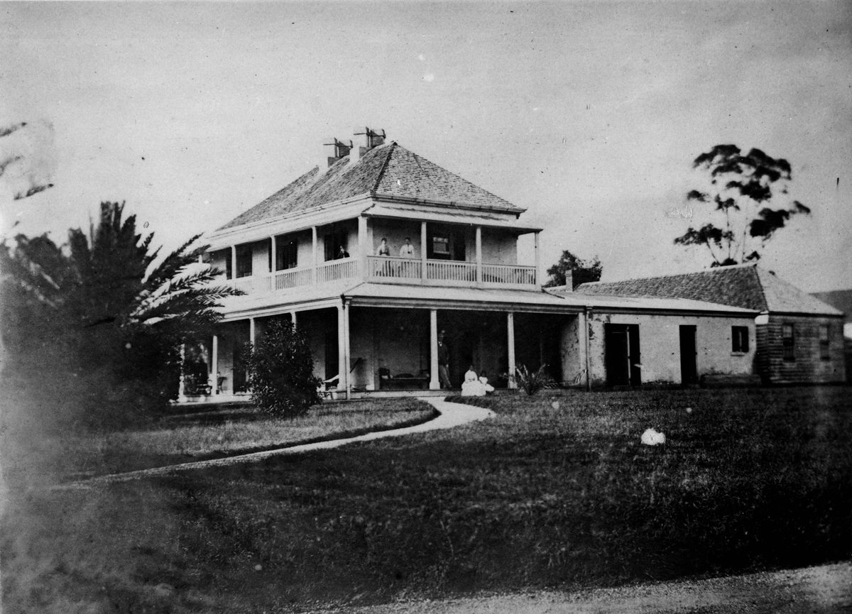 Side view of Milton House with the Manning family on the verandah, 1868
