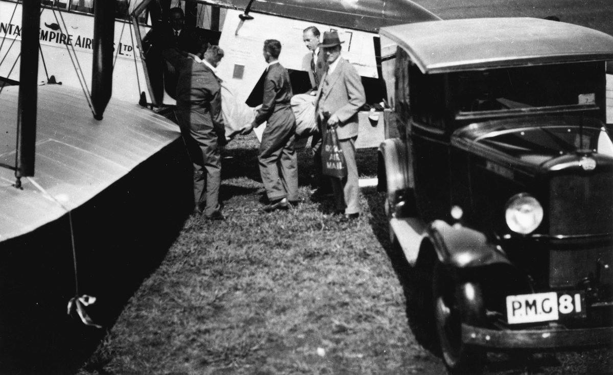 Loading the first Australia to England airmail into a De Havilland VH-UJC, Archerfield, 1934