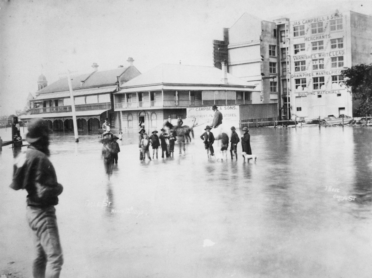 People wade through a flooded Eagle Street Brisbane during the 1980 flood