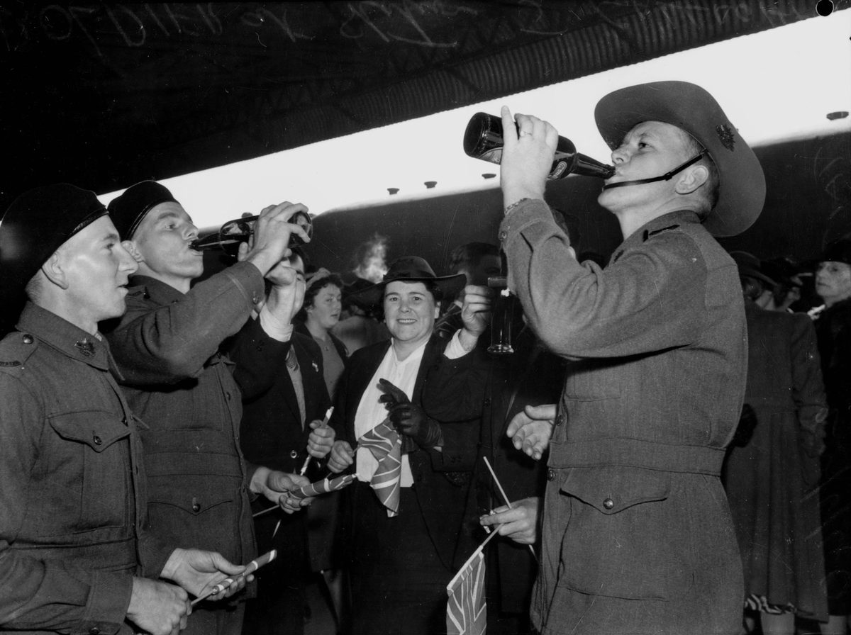 Soldiers enjoying a last drink on the train platform at South Brisbane Station, June 1940