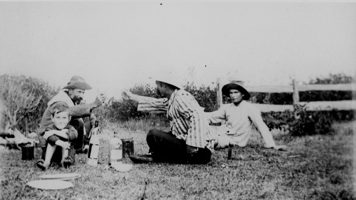 Two men and two boys having a picnic at Redcliffe, 1904