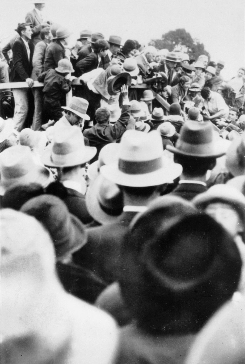 Crowds gather around Amy Johnson after her England to Australia flight in 1930