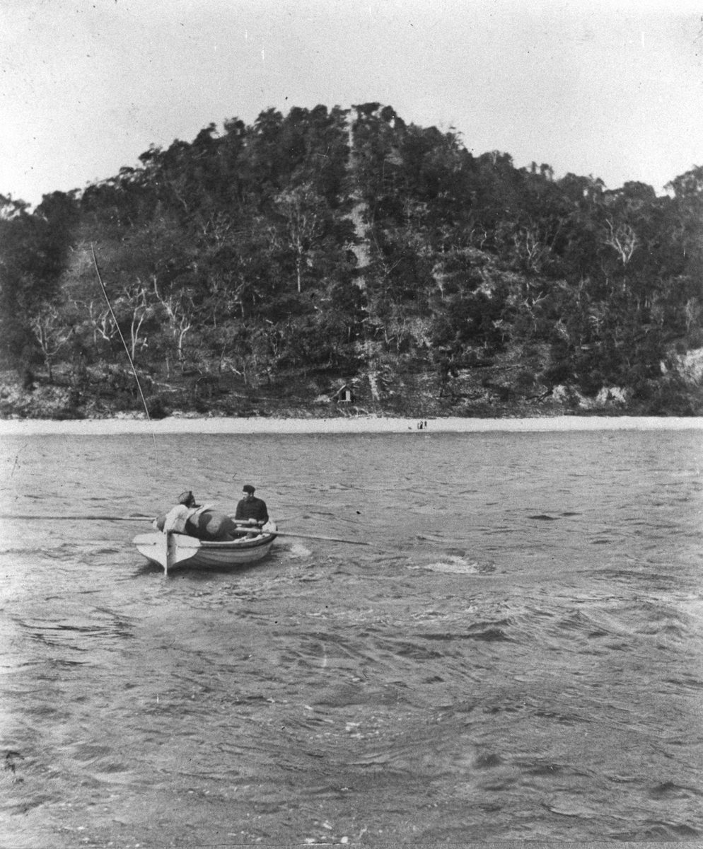 Two fishermen rowing their dinghy towards Tangalooma, Moreton Island, 1908