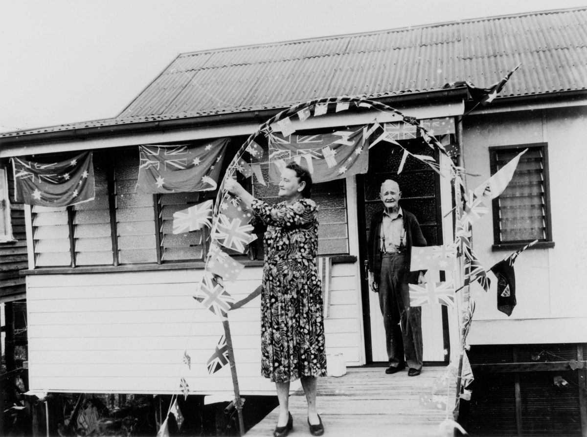 Brisbane residents decorate a cottage in preparation for the Royal Visit, March 1954