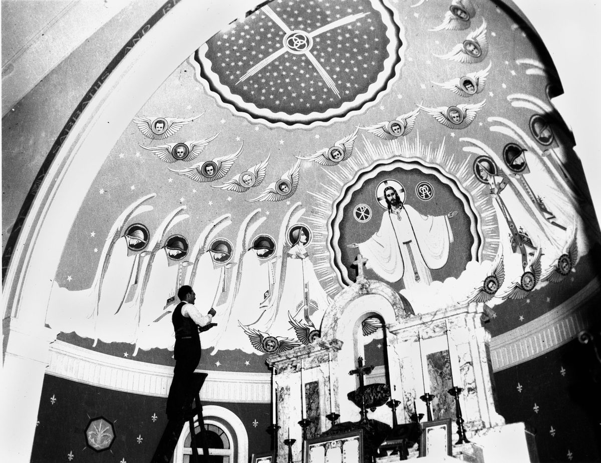 Artist James Wieneke putting the finishing touches to a mural for St Joseph's Church at Kangaroo Point in Brisbane, 1948