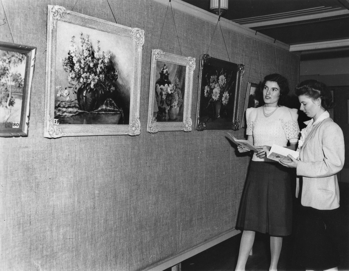 Young women admiring an exhibition of paintings at Finneys' Art Gallery, June 1948