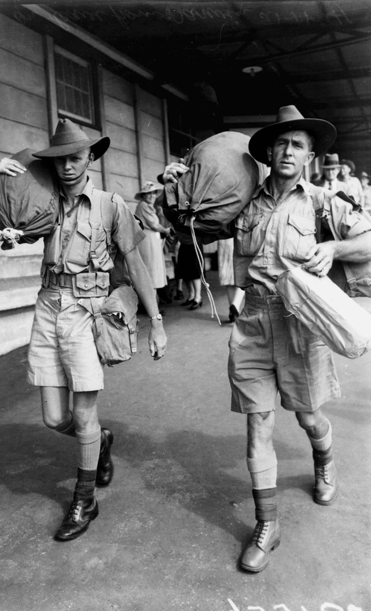 Soldiers wearing their shorts and carrying their kit bags , arriving at the railway station in Brisbane, November 1941