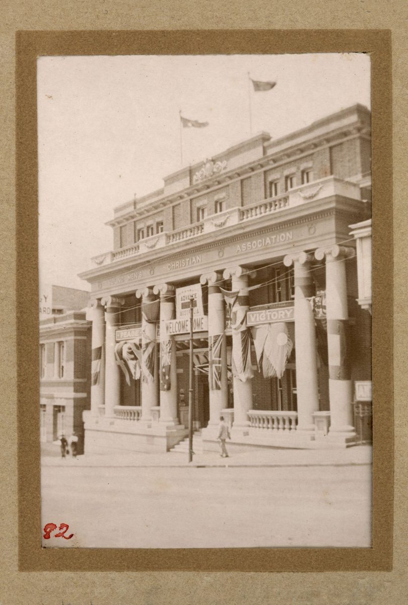 Young Men's Christian Association building draped with flags and banners