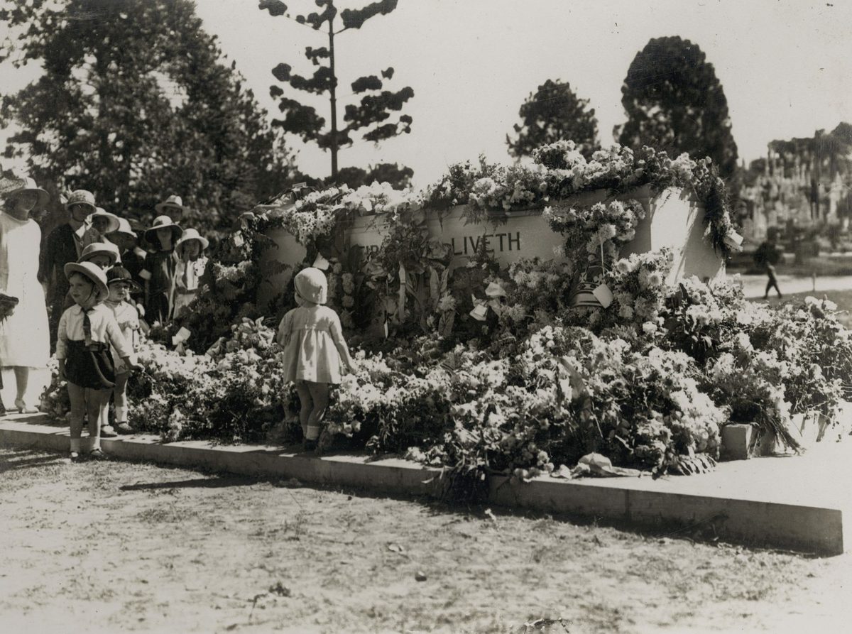 Small children looking at wreaths laid at the memorial on Anzac Day, Toowong Cemetery, Brisbane, 1924