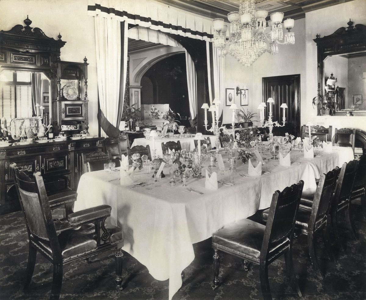 Dining room of Government House with the table prepared for dinner guests, Brisbane, 1908