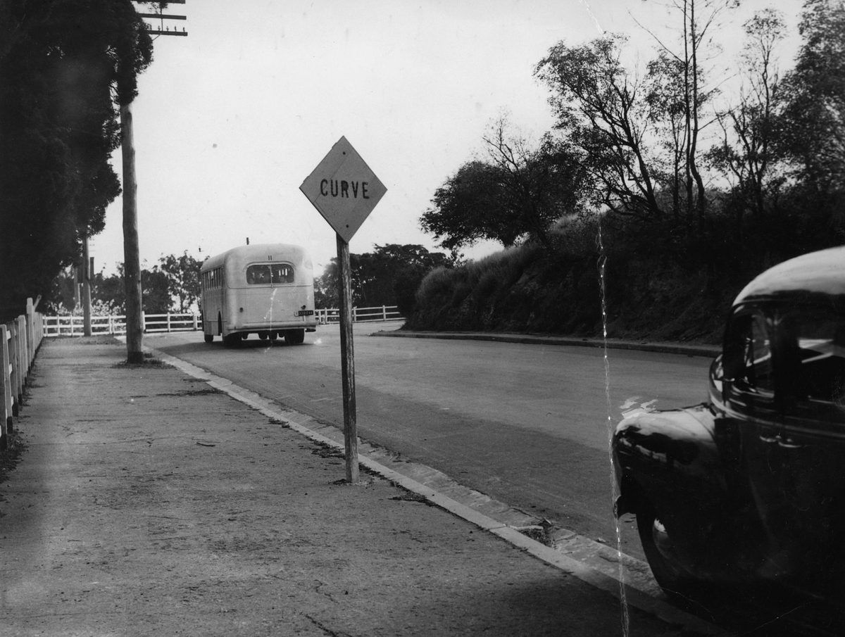 Bus travelling up a hill in Fairfield, Brisbane, 1948