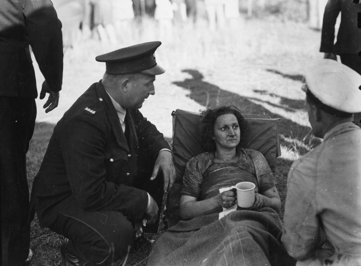 Uniformed officers attend to a female survivor of the Camp Mountain railway disaster, 1947