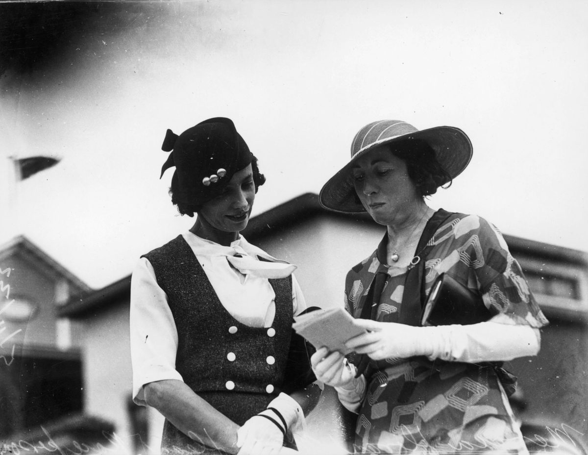 Two women picking a winner at the races, Brisbane, 1933