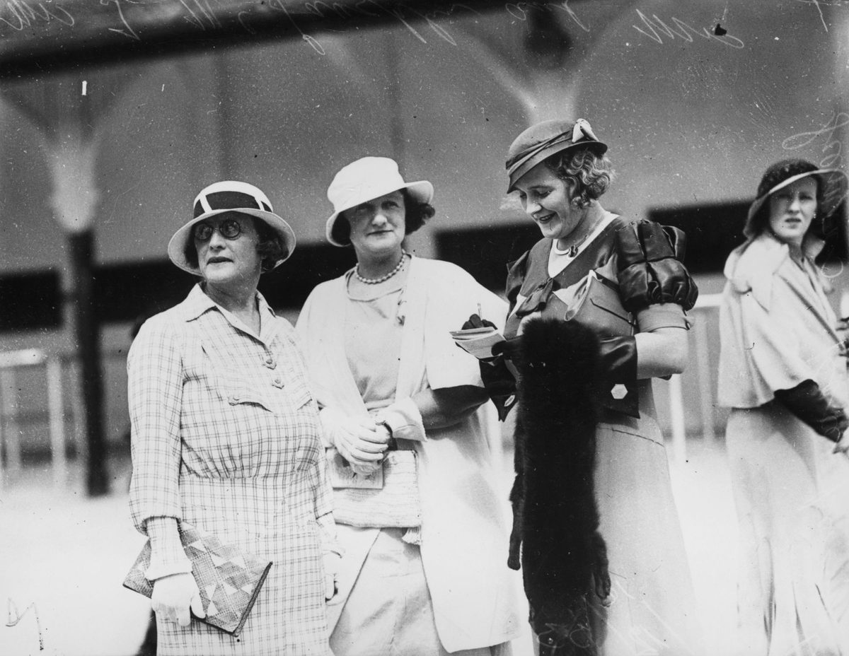 Checking the form guide at Ascot races, Brisbane, 1933
