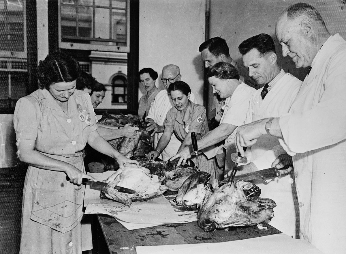Workers carve 250 turkeys for Thanksgiving Day dinners at the American Red Cross Services Club, Creek Street, Brisbane, 1942