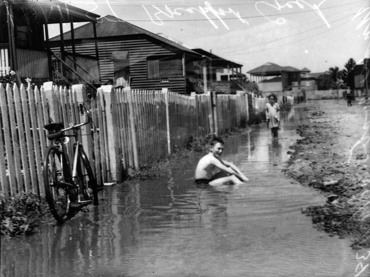 Children playing in a flooded street at Breakfast Creek in 1938