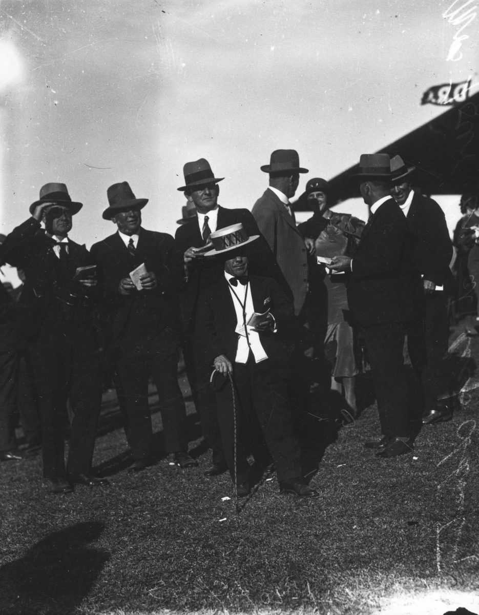 Group of well dressed gentlemen, including Mr Fourex, at the races, Doomben, Brisbane, 1933