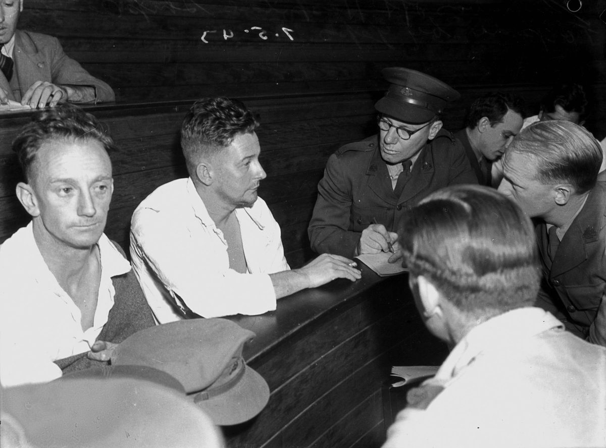 Survivors from a ship torpedoed by Japanese, being interviewed by military officers in Brisbane, May 1943
