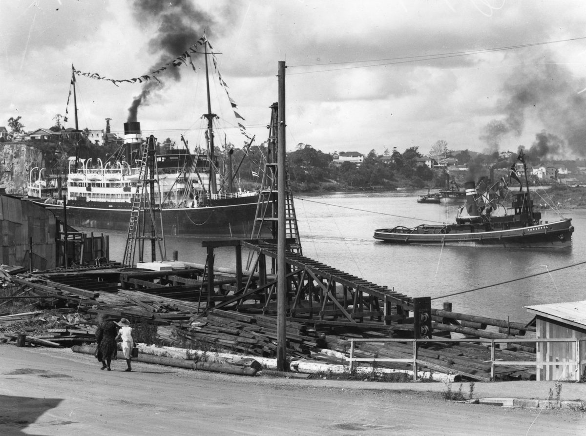 A.U.S.N ship, Orungal being pulled by the tug, Forceful up the Brisbane River. 1953