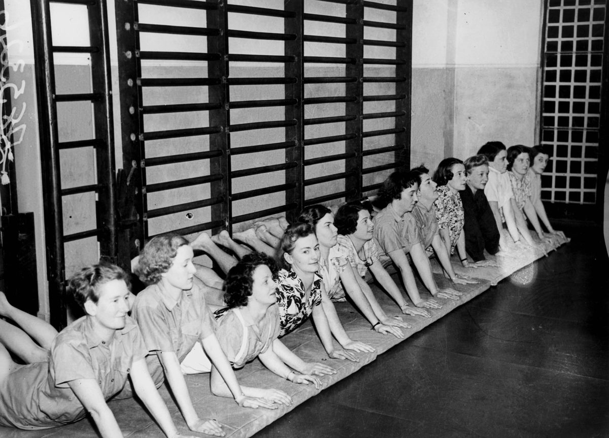 Ladies are all smiles as they perform their exercises at the Women's Australian Air Force gymnasium, Brisbane, 1942