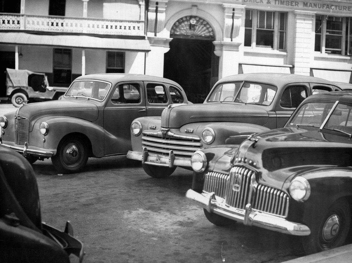 Ford V8, Austin A40 and Holden 48/215 parked in a Brisbane Street, 1952