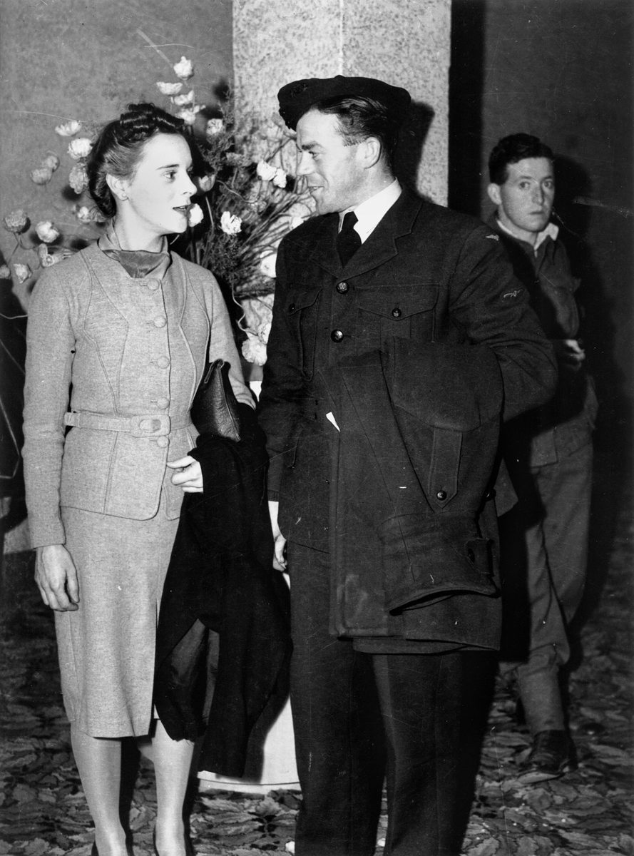 Airman and his young lady chatting in the foyer of His Majesty's Theatre, Brisbane, late July 1942