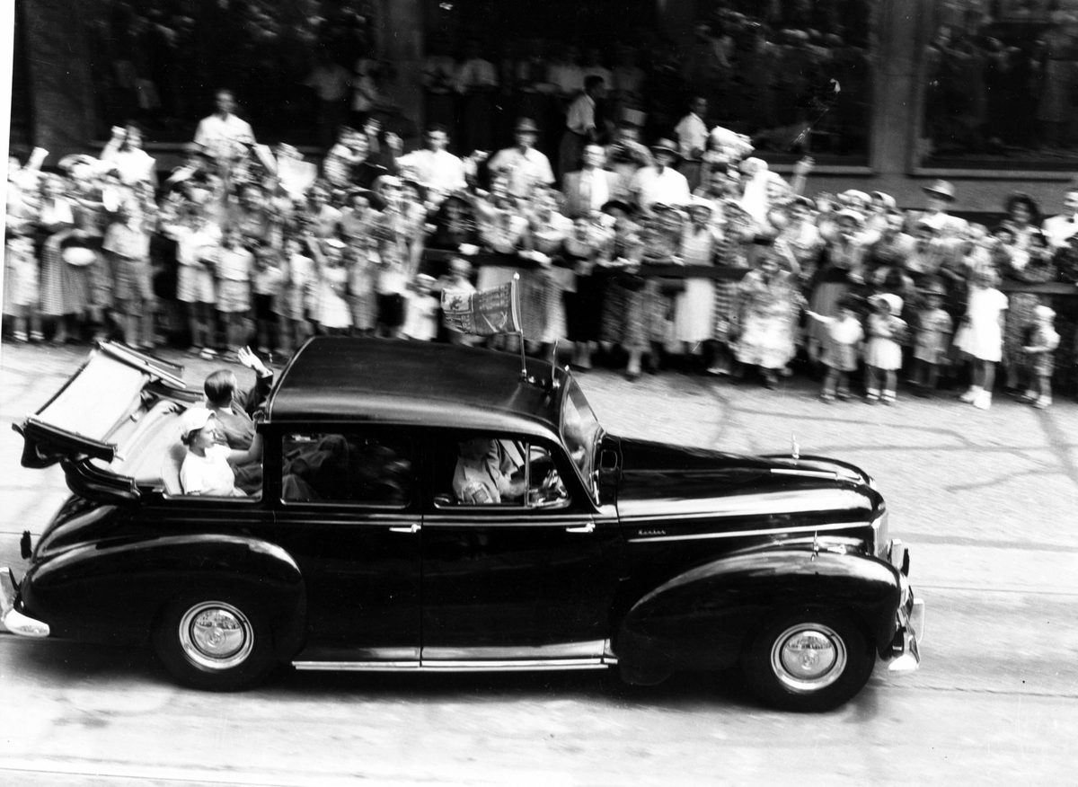 Queen Elizabeth II and Prince Philip wave to the crowds from a Humber car during their visit to Brisbane in 1954