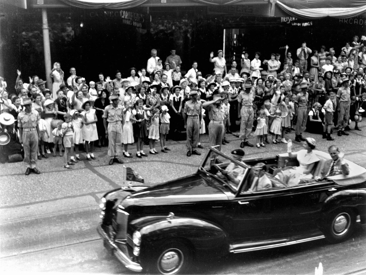 Queen Elizabeth II and the Duke of Edinburgh travel along Queen Street, Brisbane, on the last day of their Queensland tour in 1954