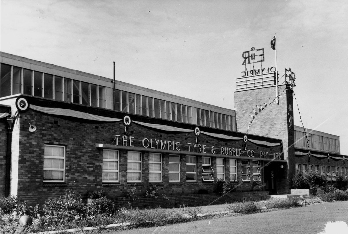 Olympic Tyre & Rubber Co. decorated their building to welcome Queen Elizabeth II and Prince Philip in 1954