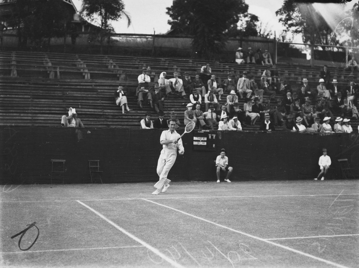 Man hitting a forehand during a tennis match in Brisbane, 1940