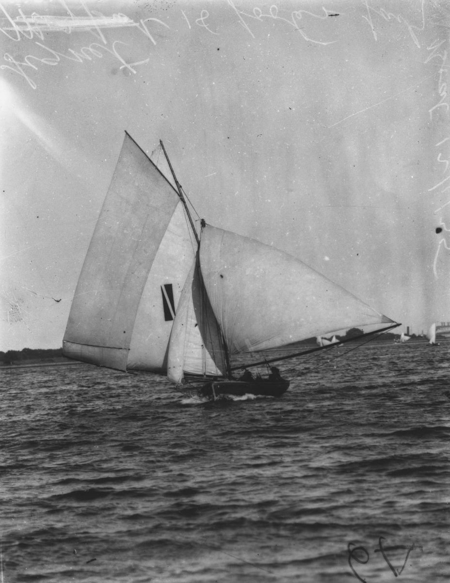 Signet an 18 footer sailing boat in full sail, 1935