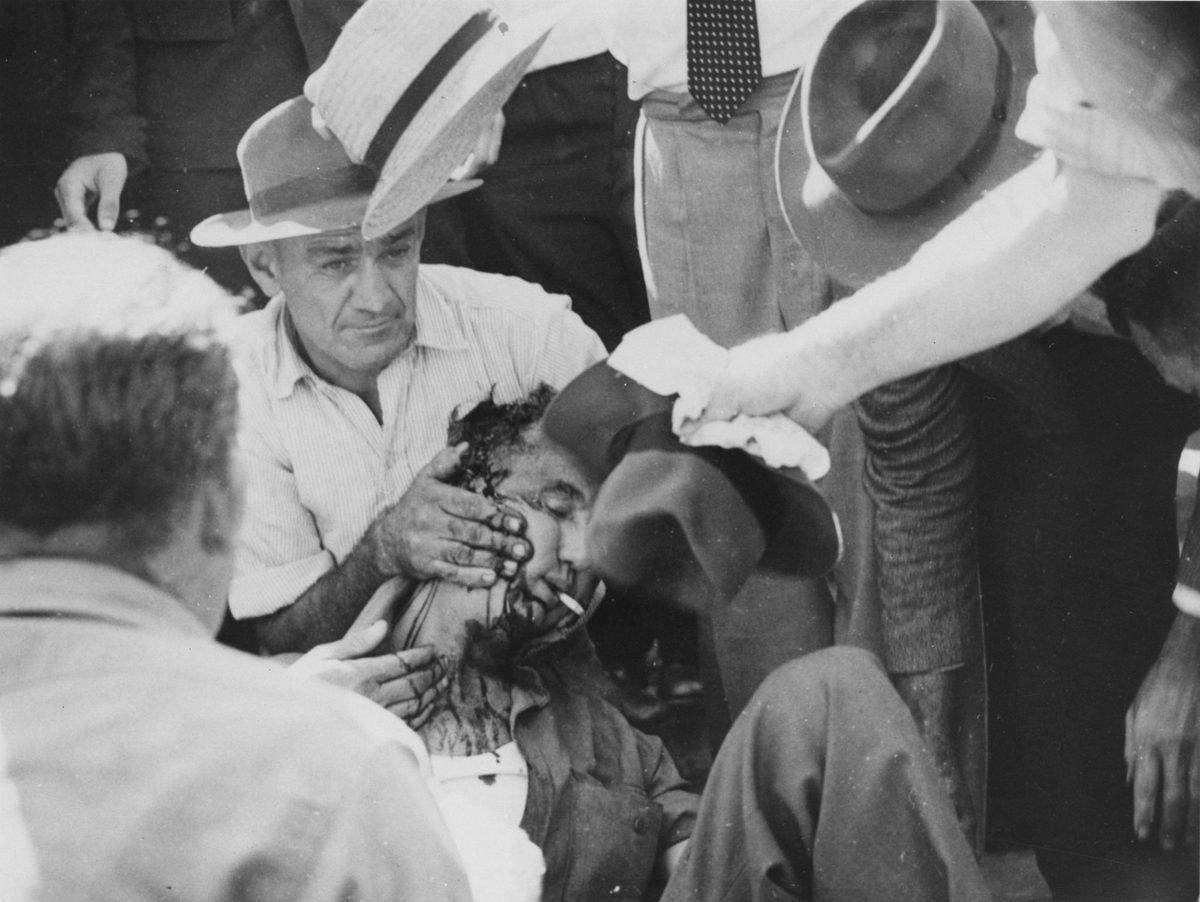 Fellow Union members assisting Jack Grayson, injured during the Railway Workers' Strike of 1948