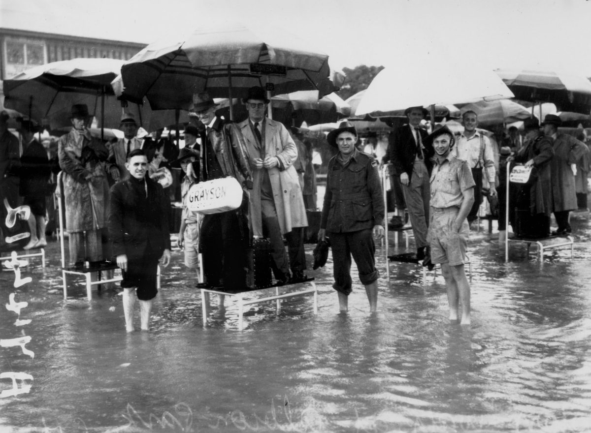 Floods in the bookmaker's ring at Albion Park Racecourse, Brisbane, 18 January 1941