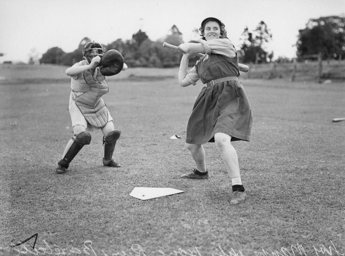 Two girls playing baseball, Brisbane, 1940