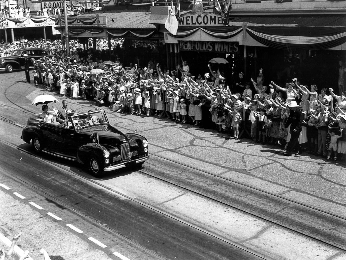 Waving to the royal visitors from Queen Street, Brisbane, 1954