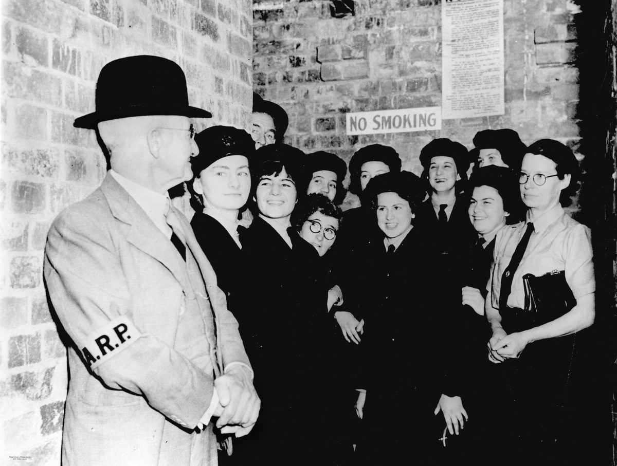 Air raid warden and members of the W.A.A.F in a Brisbane air raid shelter, 1942