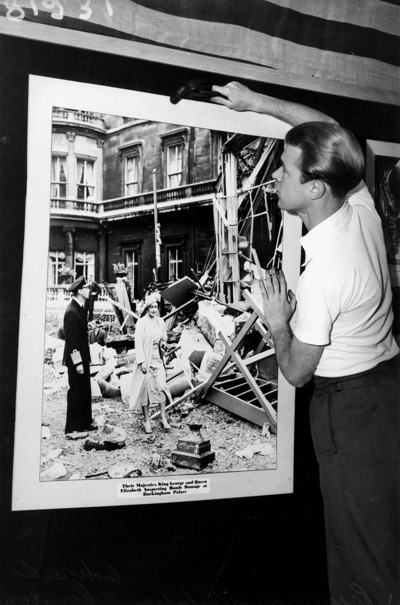 Preparing for an exhibition of photographs depicting war damage in Europe, Brisbane, November 1941