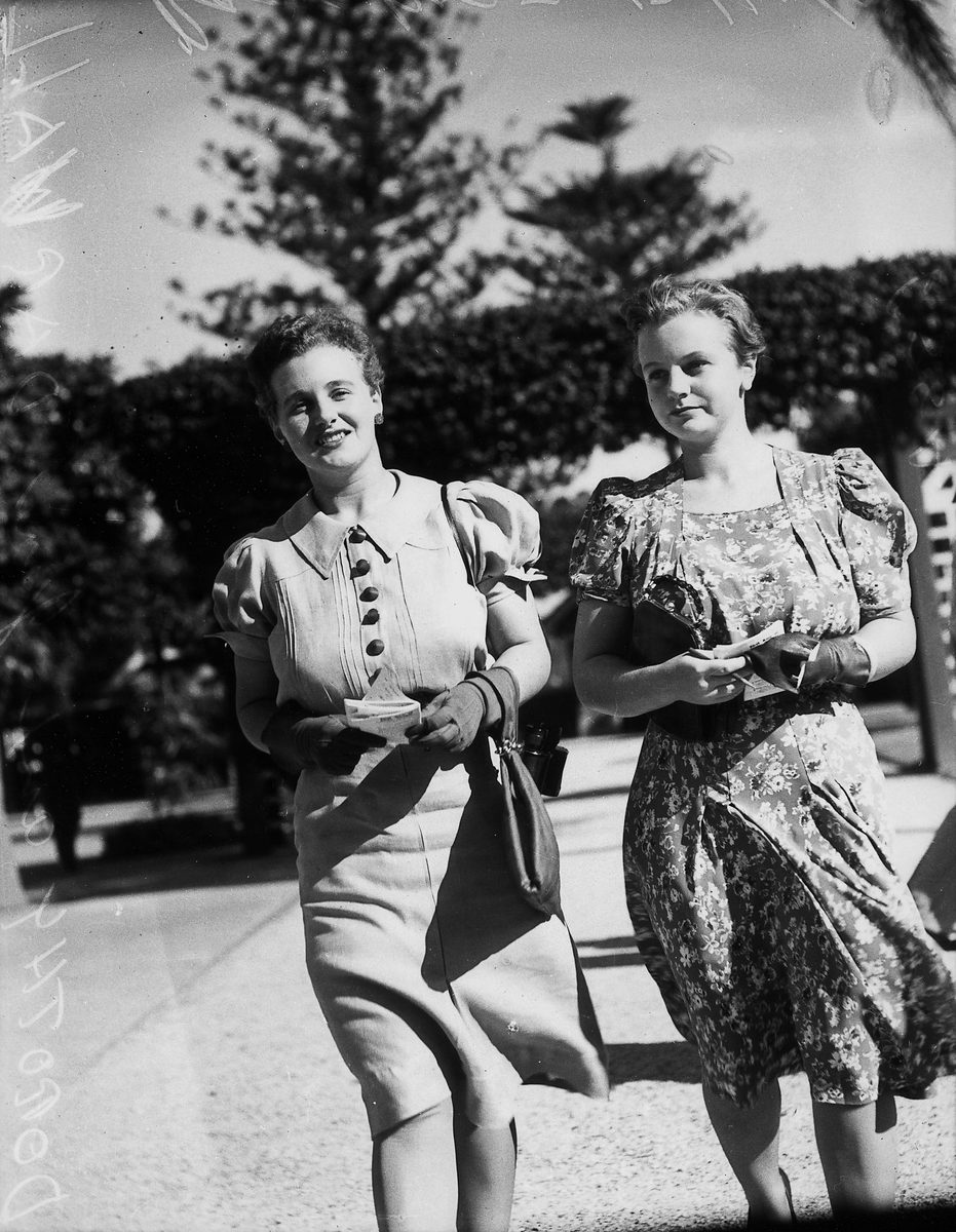 Two young women enjoying a day at the races, Brisbane, 1940