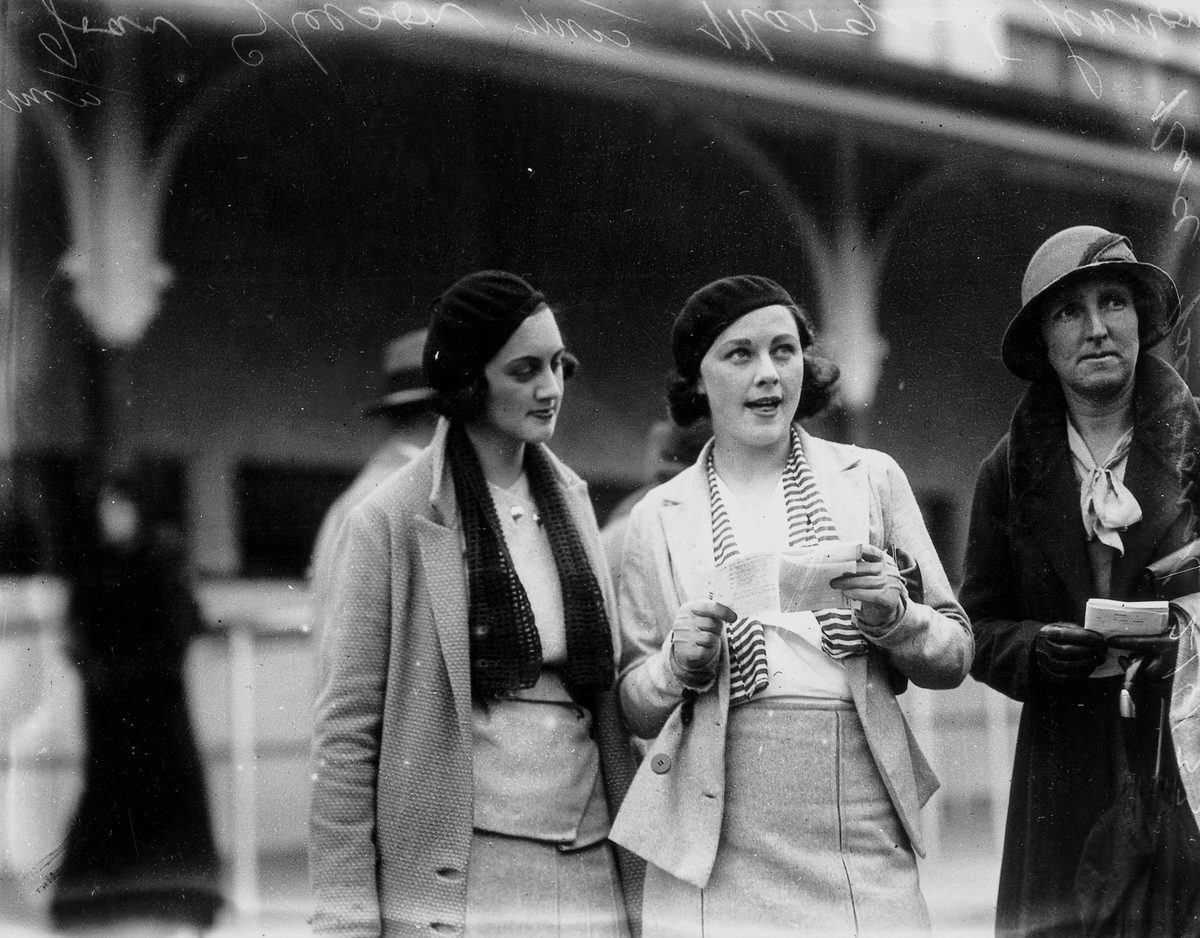 Joan Gleeson and Margaret Lennon studying the form guide at Ascot races, Brisbane, 3 June 1933