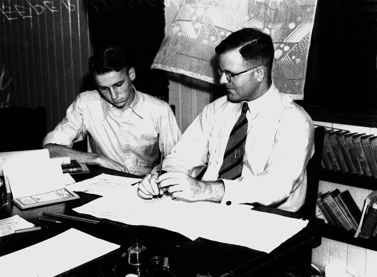 Dr. Graham Croll and R.A. Hartley discussing details of their epic health survey trip into the Far North, 1939