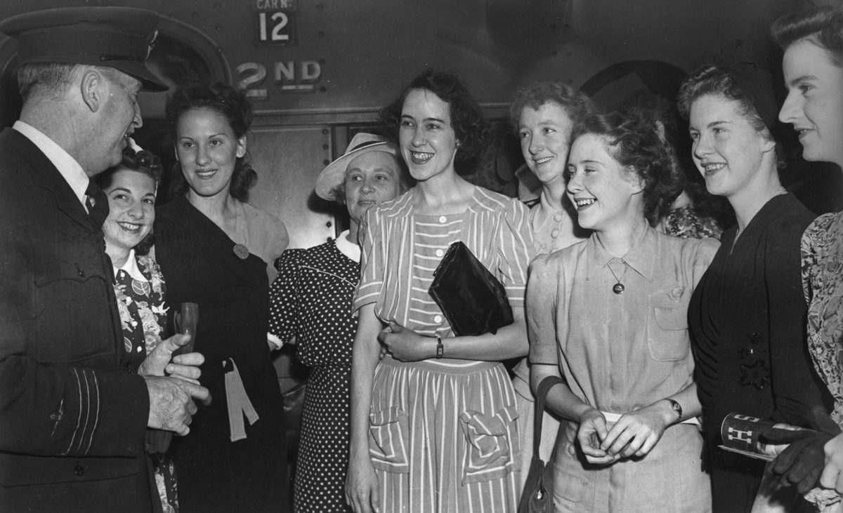 Group of girls waiting to board a train to take them south for recruit training, Brisbane, 1941