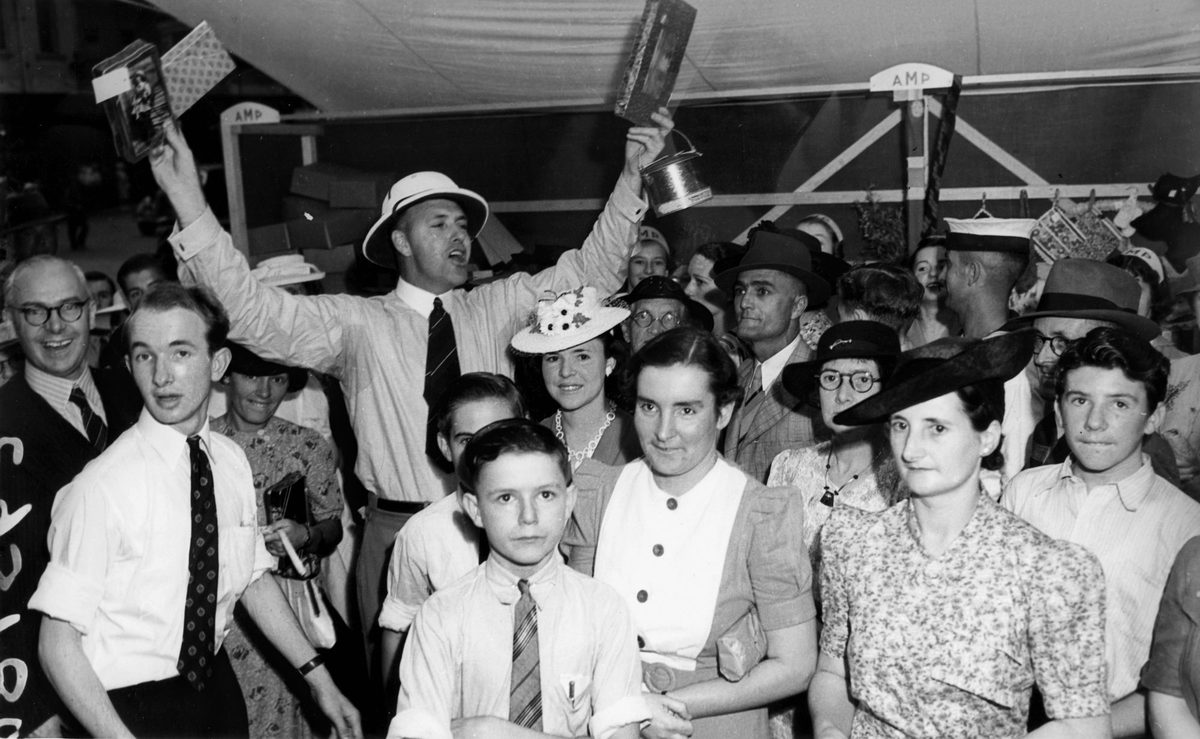 Watching the chocolate wheel at many of the Liberty Week stalls in Queen Street, Brisbane, 1941
